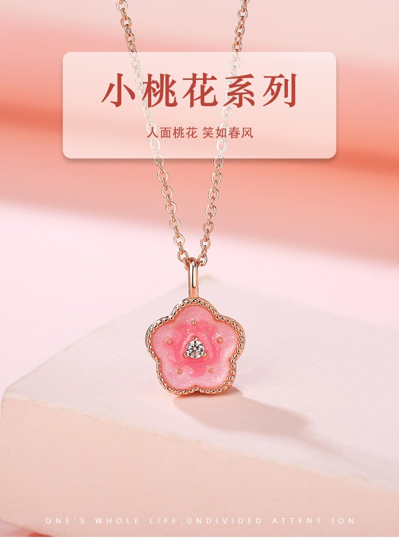 Photo of peach blossom pendant necklace. Human face with peach blossoms and smile like spring breeze